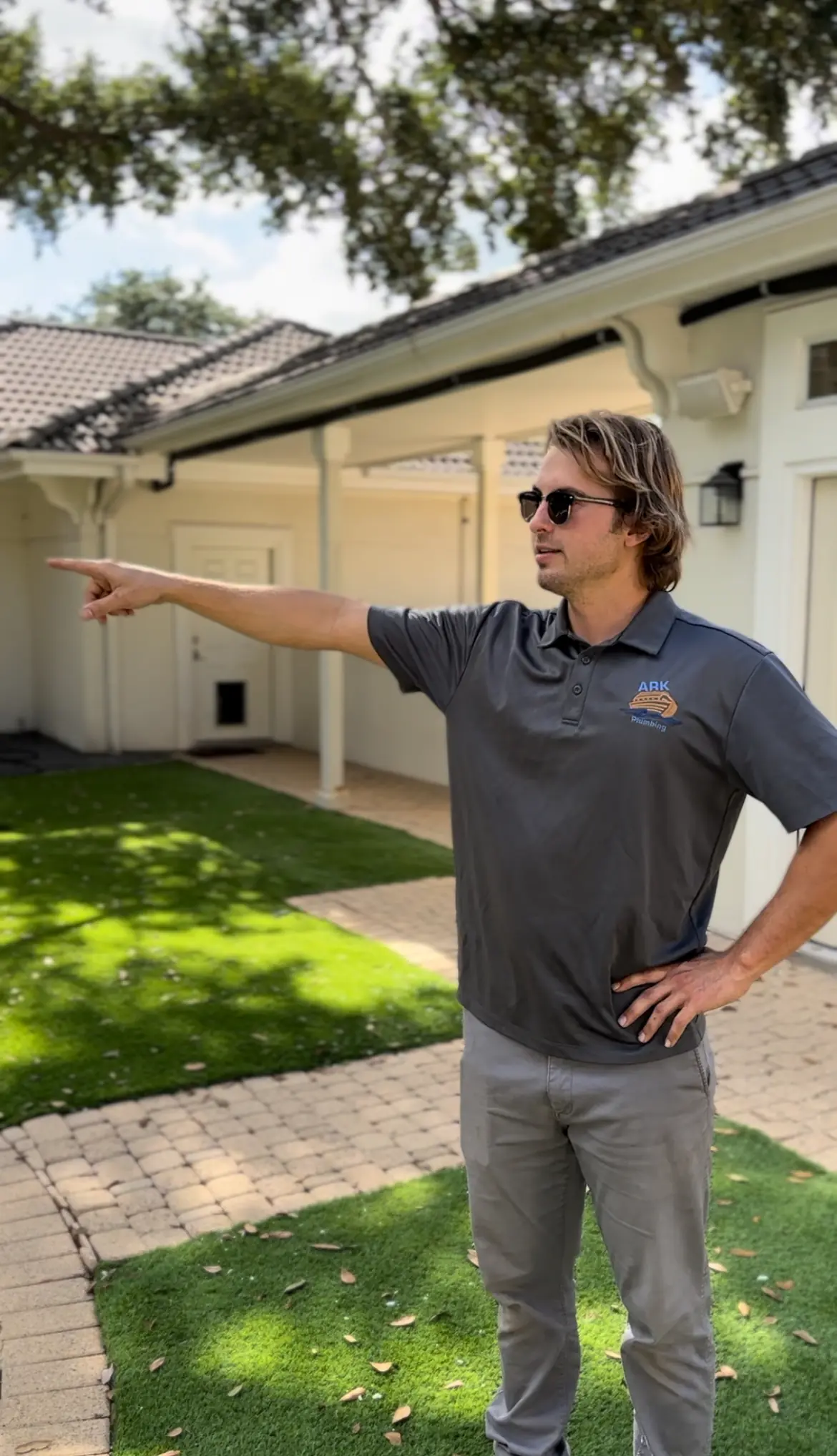 Ark plumbing technician pointing out outdoor plumbing